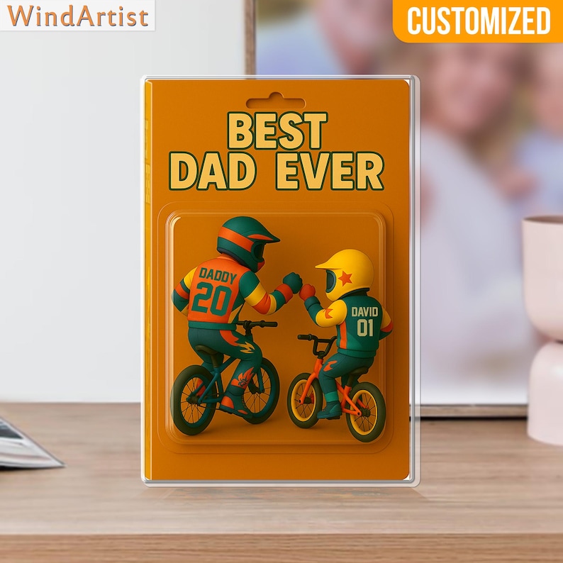 May include: A customized gift card with the text "BEST DAD EVER" on an orange background. The card features two figures on bicycles, one labeled "DADDY 20" and the other "DAVID 01", fist-bumping. The word "CUSTOMIZED" is at the top.