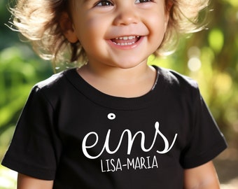 Erstes Geburtstag T-Shirt 'eins', Personalisierbar mit Namen, Bio-Baumwollshirt, Größen 0 bis 3 Jahre, Unisex Baby-Feier Outfit