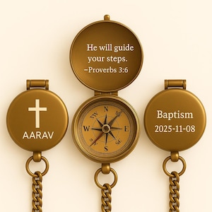 May include: A gold-coloured compass with an open lid, displaying a compass rose and the text "He will guide your steps. -Proverbs 3:6." Two circular pendants with chains are either side, one with a cross and the name "AARAV", the other with "Baptism 2025-11-08."