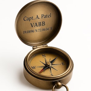 May include: A classic brass compass with an open lid, displaying a compass rose and the text "Capt. A. Patel VABB 19.0896°N 72.8656°E." The compass features a ring for attaching to a chain or lanyard.