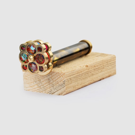 A handcrafted brass kaleidoscope that doubles as a personalized desk sculpture — the kind of object that makes every visitor pick it up and ask 'where did you get this?'