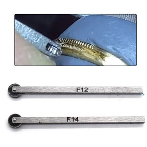May include: Two metal tools with wheels on one end. The tools are labeled "F12" and "F14".