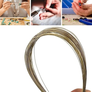 May include: A spool of gold-colored wire for jewelry making. The wire is thin and flexible, making it ideal for creating delicate jewelry pieces.