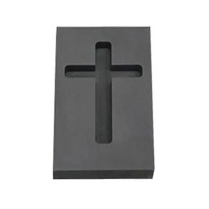 Puede incluir: Un molde de silicona negro con forma de cruz. El molde est&aacute; dise&ntilde;ado para crear un objeto con forma de cruz.