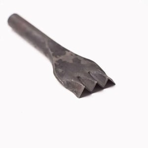 Pu&ograve; includere: Uno strumento in metallo con un manico lungo e una testa a tre punte. Lo strumento viene utilizzato per perforare il cuoio.