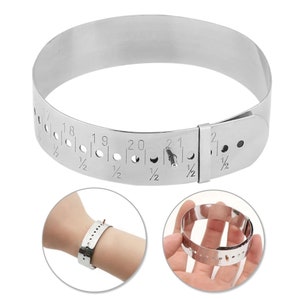 May include: A silver metal ring sizer with a measurement scale from 17 1/2 to 22 1/2. The sizer is flexible and can be used to measure the circumference of a finger.