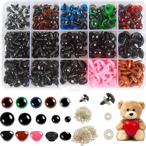 May include: A clear plastic storage box filled with various sizes and colours of plastic safety eyes for crafts. The box includes black, brown, blue, green, and pink eyes. There are also loose safety eyes and washers in the image.