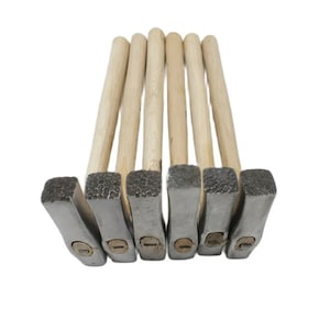 May include: A set of six small hammers with wooden handles. The hammers have square heads and are made of metal. The heads are a silver color and have a textured surface.