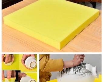 May include: A yellow foam pad for protecting delicate surfaces. The pad is shown being used to protect a ceramic vase while it is being worked on.