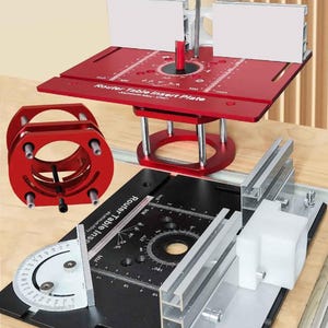May include: A red router table insert plate with a black base and silver components. The plate has a circular design with measurements in inches. The text "Router Table Insert Plate" is visible. A red support structure and a red circular component are also present.
