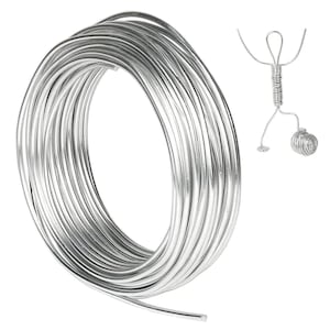 May include: A roll of silver-colored wire, perfect for crafting jewelry or other projects. The wire is coiled and ready to be used.