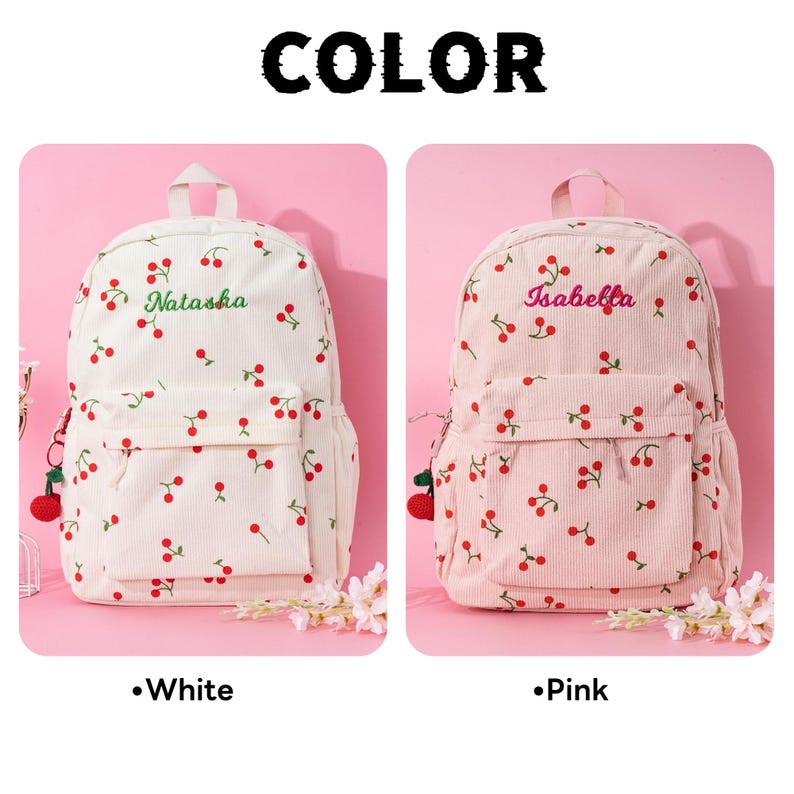 May include: Two cherry patterned backpacks, one white with the name "Natasha" embroidered in green and one pink with the name "Isabella" embroidered in pink.