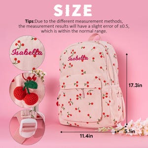 May include: Pink corduroy backpack with a cherry print and the name "Isabella" embroidered on the front. The backpack measures 44 cm tall, 29 cm wide, and 13 cm deep.