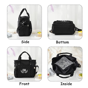May include: Black diaper bag with multiple views: side, bottom, front, and inside. The front of the bag has the initials "EM" embroidered within a laurel wreath. The bag has a top handle and a detachable shoulder strap. The inside is insulated.