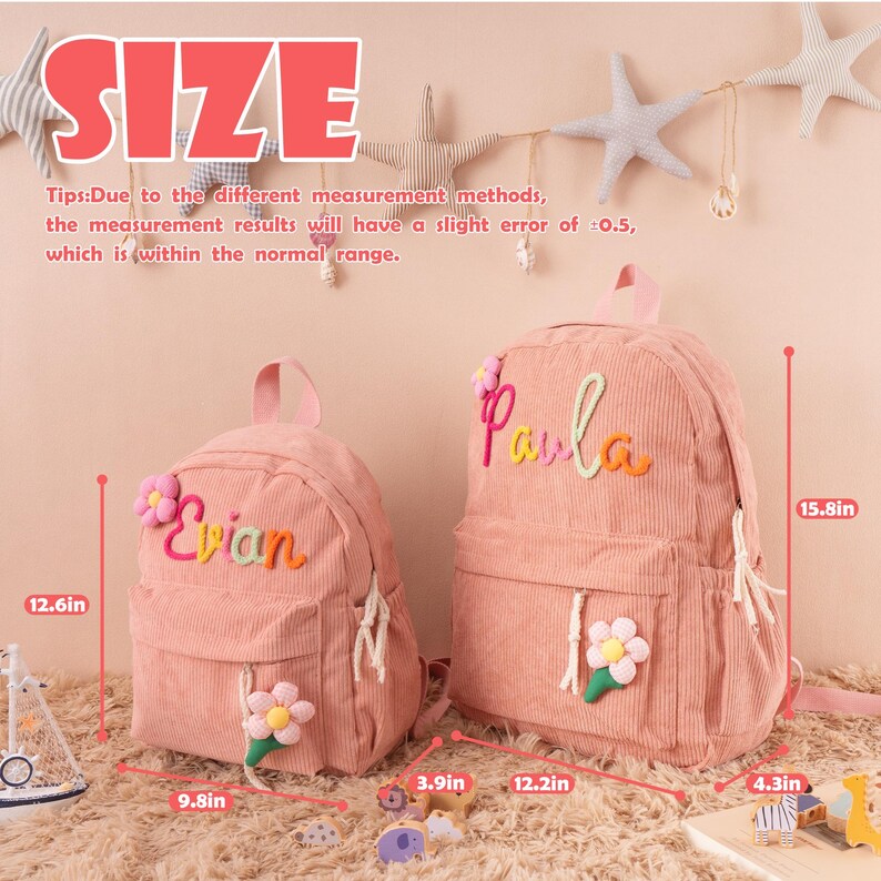 May include: Two pink corduroy backpacks. The larger backpack is 15.8 inches tall and 12.2 inches wide. The smaller backpack is 12.6 inches tall and 9.8 inches wide. Each backpack has a flower and a name embroidered on it. The text "SIZE" is at the top.
