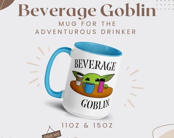 May include: White ceramic mug with a blue interior and handle, featuring the text "Beverage Goblin" and a cartoon character. The mug is available in 11oz and 15oz sizes. The text "Mug for the Adventurous Drinker" is also present.