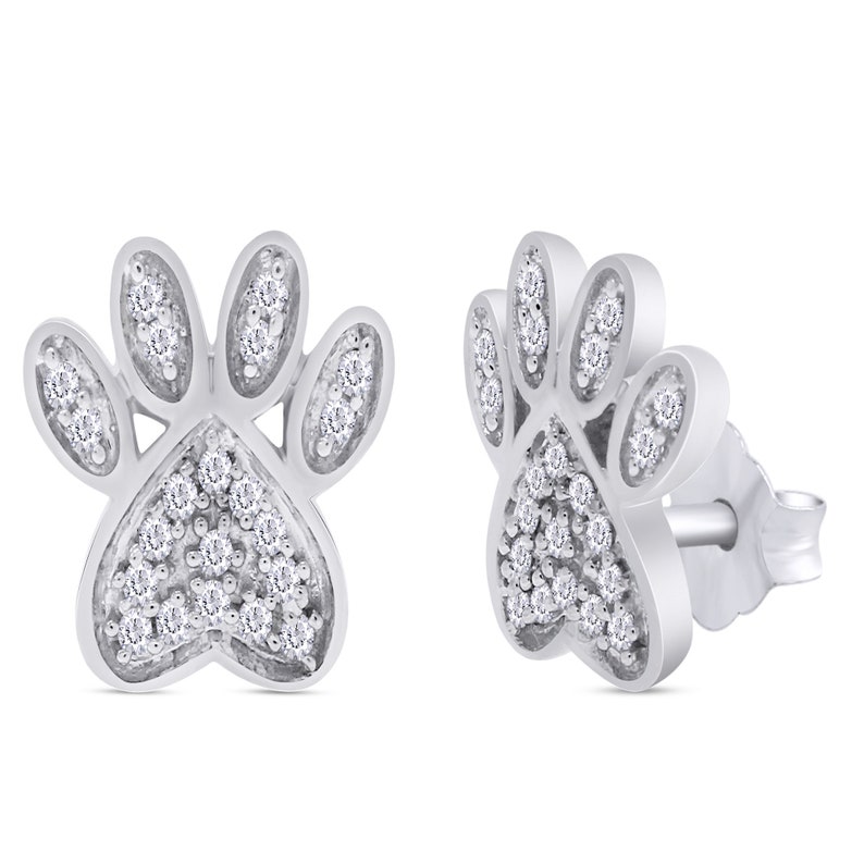 May include: A pair of silver paw print earrings with small clear cubic zirconia stones.