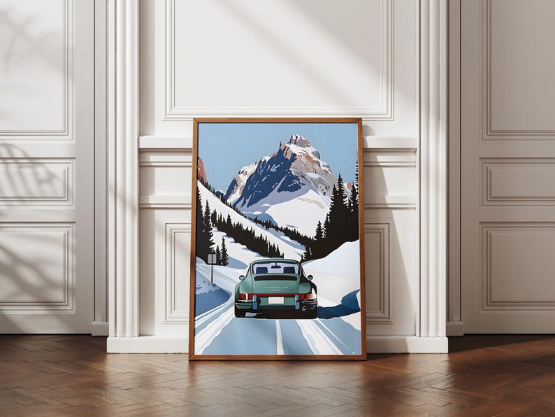 May include: A vintage green Porsche 911 driving on a snowy mountain road. The car is facing away from the viewer and the mountain peak is in the background.