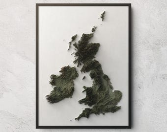 May include: A framed wall art piece featuring a three-dimensional topographic relief map of the British Isles. The landmasses are rendered in shades of dark green and brown, contrasting against a plain white background within a thin black frame.