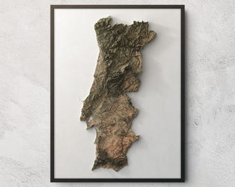 May include: A framed wall art piece featuring a three-dimensional topographic relief map of Portugal. The map displays detailed terrain textures in shades of brown, green, and grey, set against a plain white background within a thin black frame.