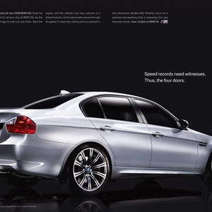 May include: A silver BMW M3 sedan with four doors. The car is parked on a black surface. The text "Speed records need witnesses. Thus, the four doors." is displayed below the car.