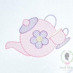 May include: Embroidered design of a pink teapot with a purple flower and a teacup. The teapot has a purple lid and handle. The design is on a white background. The text "Sweet Shiloh Baby + Child" is in the bottom right corner.