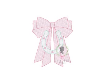 May include: A pink bow with a white horseshoe in the center. The horseshoe has small pink dots on it. The bow is tied with a ribbon and has a small floral design at the bottom.
