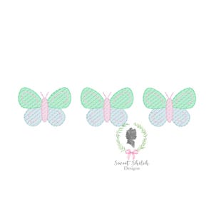 May include: Three embroidered butterflies with pink, green, and blue accents. The butterflies are arranged in a row.