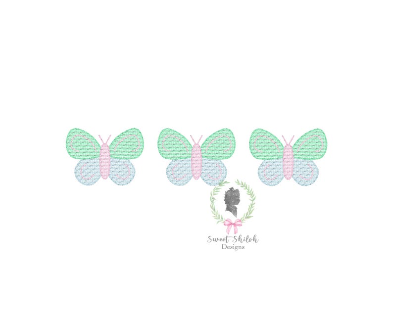 May include: Three embroidered butterflies with pink, green, and blue accents. The butterflies are arranged in a row.