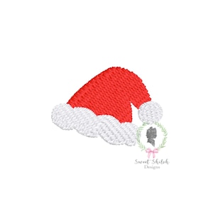 May include: Red and white embroidered Santa hat with a white pom-pom. The hat is tilted to the side.