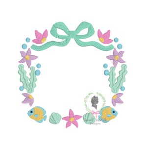 May include: An embroidered design featuring a circular frame with aquatic elements. The frame includes a teal bow, pink and purple flowers, blue bubbles, and yellow and blue fish. The text "Sweet Stitch Designs" is also included.