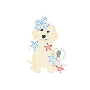 May include: A yellow Labrador Retriever puppy wearing a blue bow and holding a string of red and blue stars. The puppy is sitting on a white background.