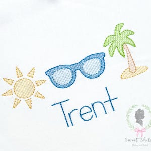 May include: Embroidered design featuring a yellow sun, blue sunglasses, and a green palm tree on a small patch of sand. The name "Trent" is stitched in blue. The design is on a white background.