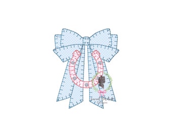 May include: A blue and white polka dot bow with a pink horseshoe in the center. The horseshoe is decorated with a small floral arrangement. The text "Sweet Shishkabob Designs" is at the bottom of the image.