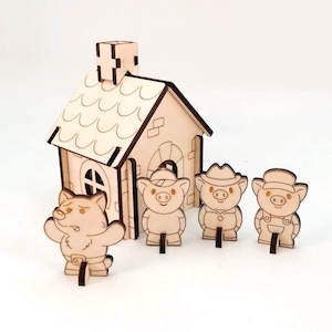 以下が含まれることがあります： 木製の玩具セット。3匹の豚とオオカミ、背景には家があります。豚は帽子とオーバーオールを着ており、オオカミはいたずらっぽい表情をしています。