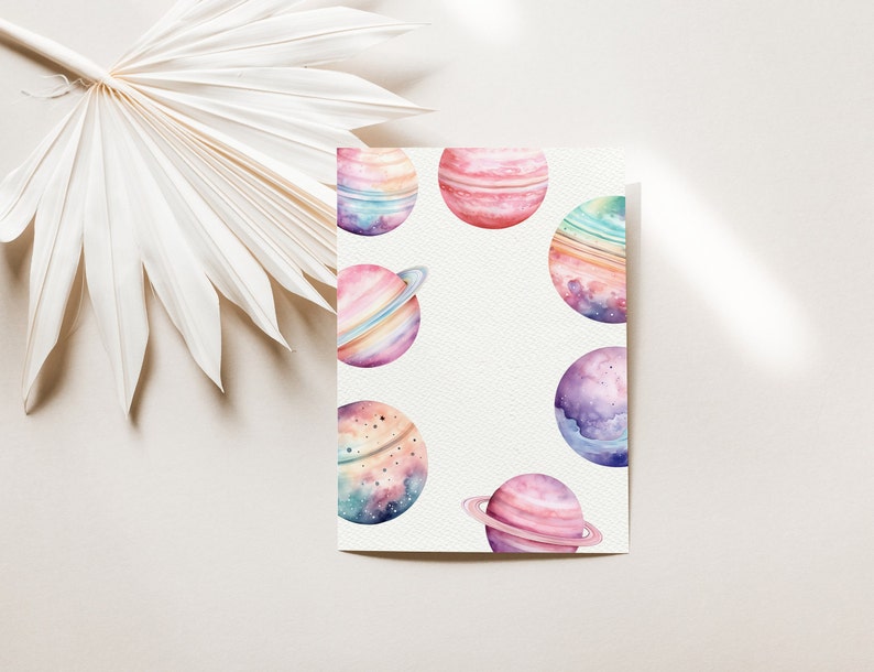 May include: Watercolor painting of planets in shades of pink, purple, blue, and green. The planets have rings and are surrounded by a white background.