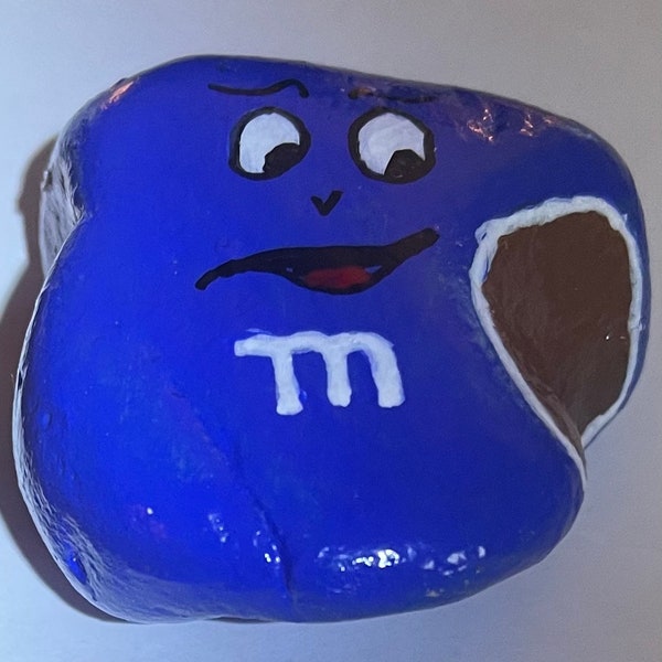 Hand painted rock of bitten M&M