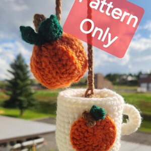 May include: Crochet pattern for a pumpkin mug cozy. The cozy is white with an orange pumpkin applique. The pattern is for a small pumpkin, about the size of a teacup.