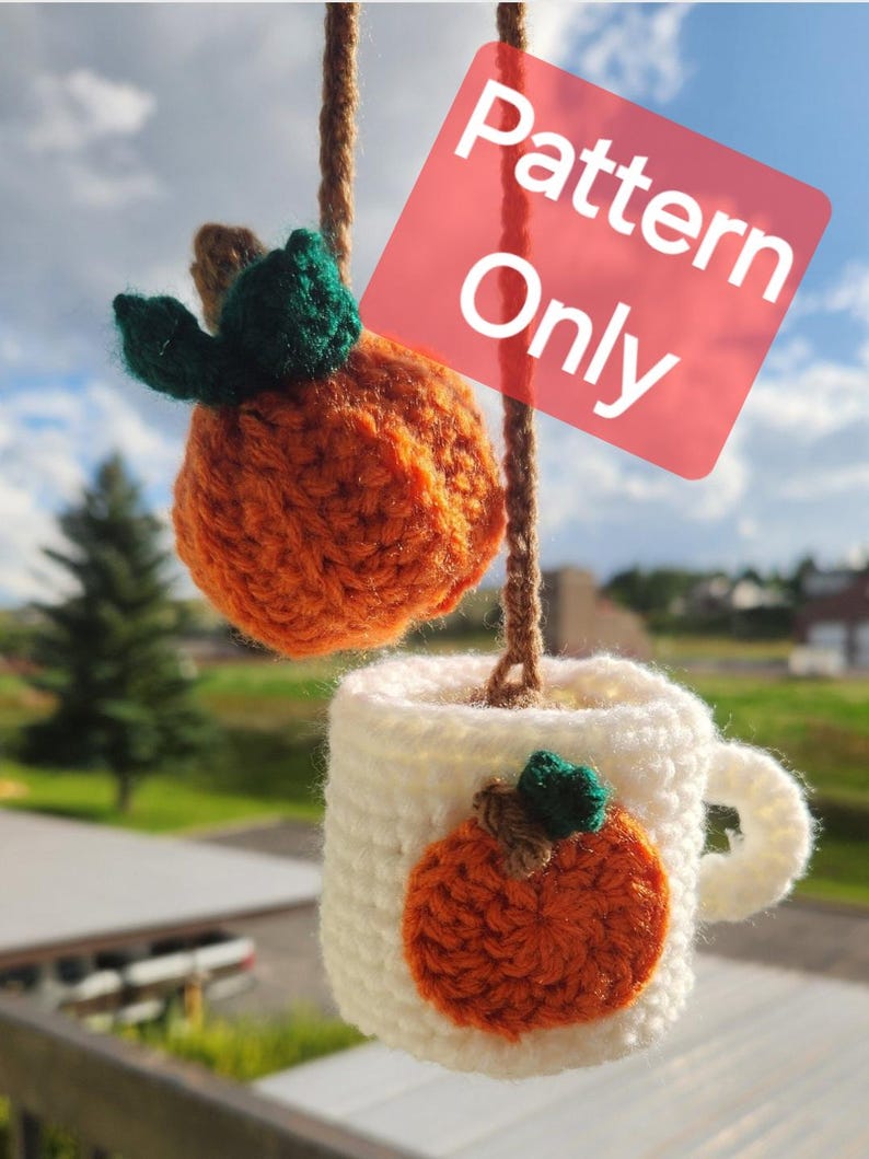May include: Crochet pattern for a pumpkin mug cozy. The cozy is white with an orange pumpkin applique. The pattern is for a small pumpkin, about the size of a teacup.