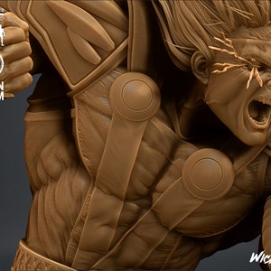May include: Close-up of a 3D printed figurine of a muscular figure with a detailed face and a textured, layered costume. The figure has a fierce expression with its mouth open and its eyes wide. The figurine is printed in a brown colour and appears to be made of resin.