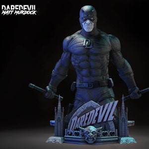 May include: A detailed statue of Daredevil, Matt Murdock, in a dynamic pose, holding batons. The figure is predominantly dark blue with a white mask and the letter "D" on the chest. The base features the word "DAREDEVIL" and a gargoyle.