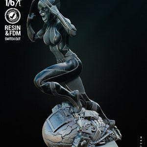 May include: A black and silver 3D printed figurine of a female superhero with claws, standing on a broken metal object. The figurine is posed in a dynamic action pose. The text "WICKED" is visible in the lower right corner of the image.