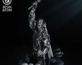 May include: A detailed, gray-scale 3D printed model of the Predator from the movie franchise. The figure is holding a burning torch and is standing on a base with skulls and jungle foliage. The base has the word "PREDATOR" printed on it. The figure is 1/4 scale and is made of resin.