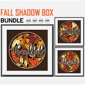 May include: A set of three fall-themed shadow box designs featuring a circle of autumn leaves with the words "thankful", "grateful", and "blessed" in a handwritten font.