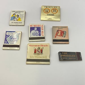 May include: Collection of vintage matchbook covers. The covers feature various designs, including a restaurant, a hotel, a seafood restaurant, and a stuffed cabbage roll. The covers are all in different colors and styles.
