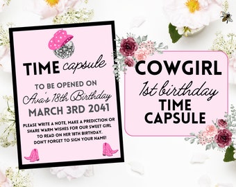 May include: Pink and white time capsule sign with a cowgirl theme. The sign says "Cowgirl 1st birthday Time Capsule".