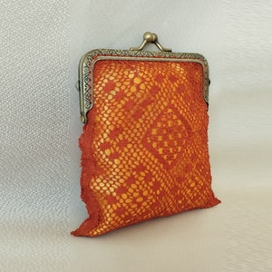 Bobbin lace purse with rayon thread and brass clasp with aged bronze finish.