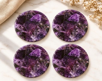 May include: A set of four circular coasters crafted from polished amethyst stone, featuring deep purple and violet hues with natural crystalline patterns and jagged, dark inclusions visible throughout the smooth, reflective surface of each piece.