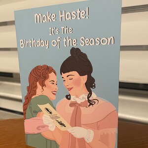 May include: A blue card with the text "Make Haste! It's the Birthday of the Season" and an illustration of two women in period clothing smiling at each other.