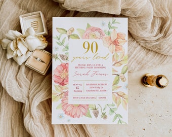 May include: A floral-themed invitation for a 90th birthday party. The invitation features a watercolour illustration of pink and orange flowers, green leaves, and berries. The text reads "90 years loved" and "Please join us for a birthday party honouring Sarah James". The date, time, and location of the party are also included.